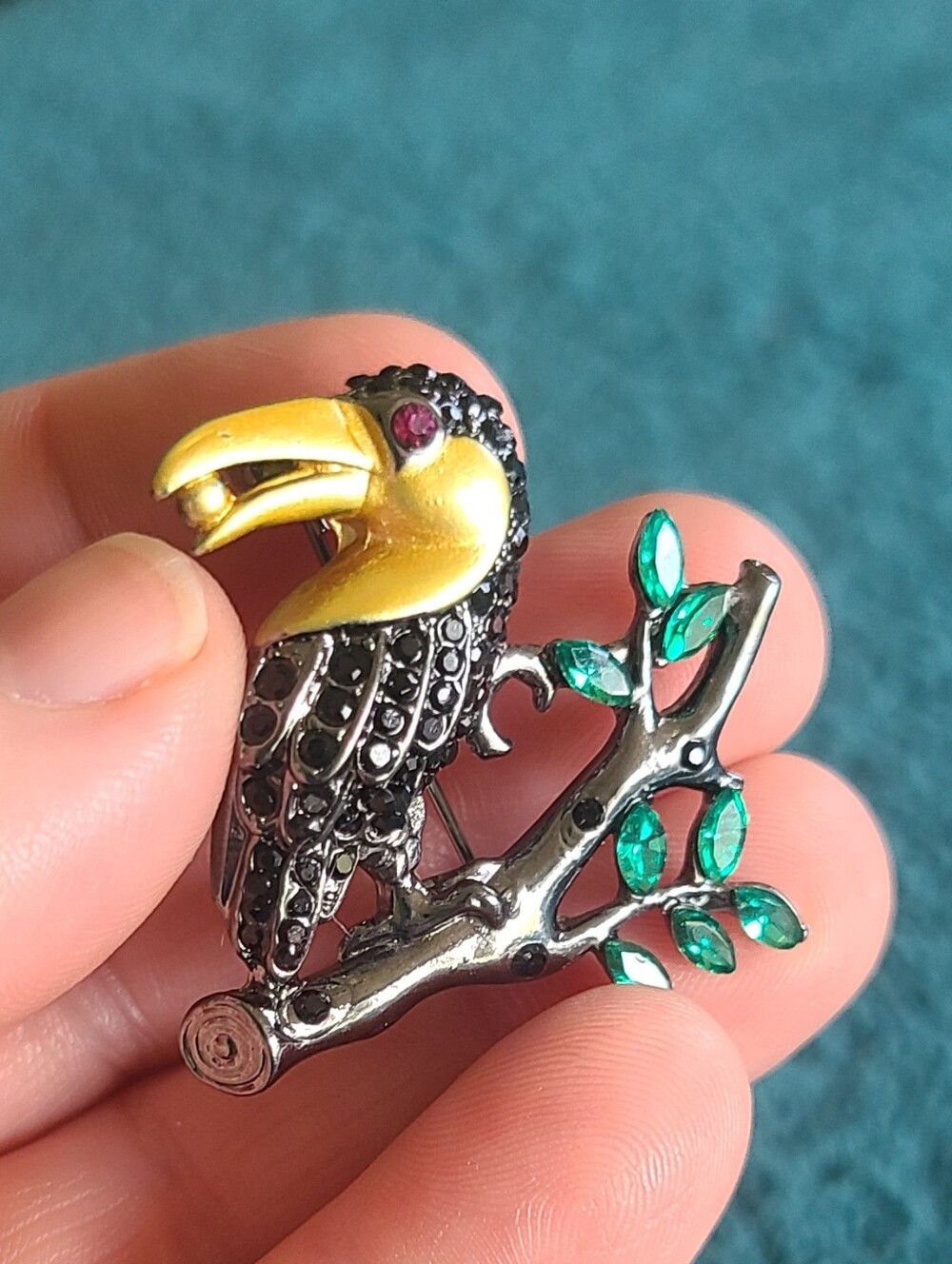 Vintage Gold-Accented Black Toucan Brooch with Green Leaves
